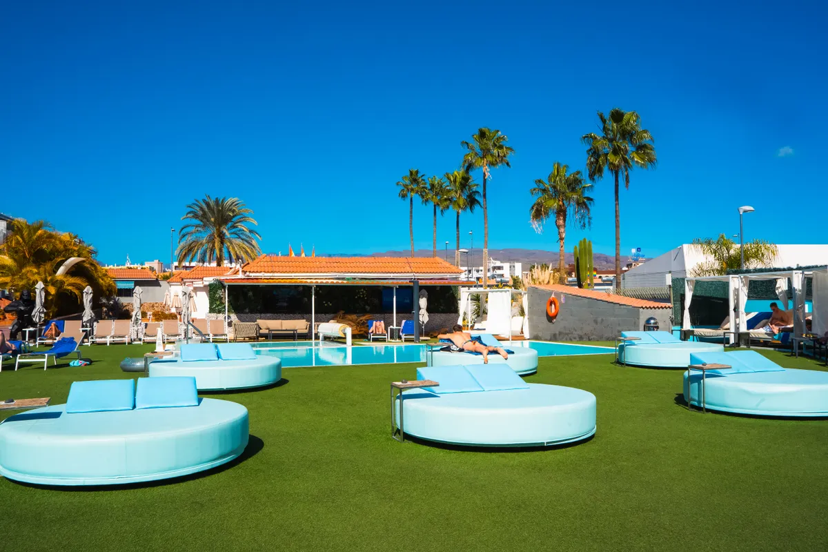 Guests by the heated pool at gay resort Aqua Beach Bungalows in Playa del Inglés